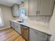Renovated kitchen featuring gray cabinets, quartz countertops, and stainless steel appliances at 2117 Arden Dr, Monroe, NC 28112