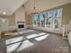 Sunlit living room with a fireplace, vaulted ceiling and access to deck at 2117 Arden Dr, Monroe, NC 28112