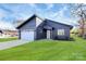 Dark gray siding, white garage door, and a well-maintained lawn characterize this modern home at 2601 Mcgill St, Kannapolis, NC 28081