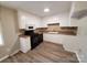 Kitchen with white cabinets, black appliances, and vinyl flooring at 2824 Dalecrest Dr, Charlotte, NC 28269