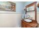Charming bathroom with antique vanity, pedestal sink, and unique light fixtures at 318 N Elm St, Marshville, NC 28103
