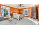 Bedroom with vibrant orange walls, hardwood floors, and unique furniture at 318 N Elm St, Marshville, NC 28103
