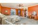 Cozy bedroom with orange walls, vintage furniture, and a view from the window at 318 N Elm St, Marshville, NC 28103