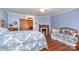 Spacious bedroom with fireplace, wooden accents, and soft blue walls at 318 N Elm St, Marshville, NC 28103