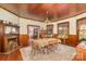 Dining room with fireplace, wood paneling, and large windows at 318 N Elm St, Marshville, NC 28103