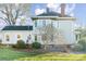 Two-story home with gray siding, brick chimney, and landscaped yard at 318 N Elm St, Marshville, NC 28103