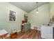Charming vintage kitchen with green cabinetry, wood floors, and unique light fixture at 318 N Elm St, Marshville, NC 28103