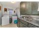 Laundry room with washer, dryer, sink, and cabinets at 318 N Elm St, Marshville, NC 28103