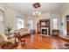 Elegant living room with fireplace, hardwood floors, and large windows at 318 N Elm St, Marshville, NC 28103