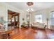 Spacious living room with hardwood floors, large windows, and vintage furniture at 318 N Elm St, Marshville, NC 28103