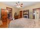 Main bedroom featuring hardwood floors, a fireplace, and vintage furniture at 318 N Elm St, Marshville, NC 28103