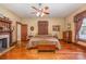 Spacious main bedroom with hardwood floors, fireplace, and large bed at 318 N Elm St, Marshville, NC 28103