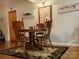 Dining area with wooden table and lake themed art at 369 Pinecrest Cir, Troy, NC 27371