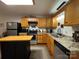 Kitchen with wood cabinets, granite counters and island at 369 Pinecrest Cir, Troy, NC 27371