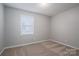 Simple bedroom with neutral walls, carpet, and a window at 501 Mt Sinai Church Rd # 18, Shelby, NC 28152