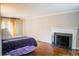 Bright bedroom with hardwood floors, fireplace, and yellow curtains at 505 Briarwood Rd, Lancaster, SC 29720