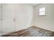 Small office space with wood-look flooring and an exterior door at 5103 Heathland Dr # 50, Charlotte, NC 28215