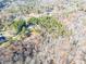 Aerial view showcasing house and surrounding wooded area at 5164 Green Rd, Stanley, NC 28164