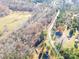 Wide shot of property showing house, road, and surrounding land at 5164 Green Rd, Stanley, NC 28164