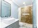 Modern bathroom with herringbone tile shower and gray vanity at 5164 Green Rd, Stanley, NC 28164