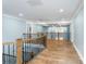 Spacious second floor hallway with hardwood floors and stylish railing at 5164 Green Rd, Stanley, NC 28164