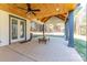 Covered patio with wood ceilings, ceiling fan, and access to backyard at 5164 Green Rd, Stanley, NC 28164