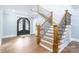 Elegant wooden staircase with black metal railing at 5164 Green Rd, Stanley, NC 28164
