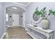 Elegant entryway with tile floors, arched doorway, and a white console table with decor at 6110 Paw Village Rd, Charlotte, NC 28214