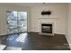 Bright living room featuring a fireplace and access to a deck at 7428 Ashfield Ct, Charlotte, NC 28226