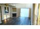 Living room featuring a corner fireplace, hardwood floors, and sliding glass doors at 8633 Sawleaf Ct, Charlotte, NC 28215