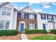 Brick front townhouse with blue door and well-manicured landscaping at 9149 Washam Potts Rd, Cornelius, NC 28031