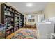 Well-equipped laundry room with washer, dryer, and ample storage shelves at 1008 Candlewood Ln, Rock Hill, SC 29730