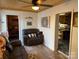 Cozy living room featuring a comfortable recliner and views into a bedroom and kitchen at 101 Lake View Dr, Mount Gilead, NC 27306