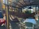 Relaxing patio area with pergola, table, chairs, and fire pit at 101 Lake View Dr, Mount Gilead, NC 27306