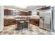 Kitchen with dark brown cabinets and a stainless steel refrigerator at 1061 Sundance Dr, Gastonia, NC 28054