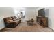 Living room with brown leather reclining sofas and a media console at 1061 Sundance Dr, Gastonia, NC 28054