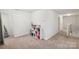 Bright hallway with ample storage and a mirrored wall at 1065 Ramsgate Sw Dr, Concord, NC 28025