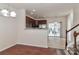 Dining room with hardwood floors, kitchen access and view of staircase at 11121 Kanturk Ct, Charlotte, NC 28213