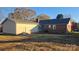 Rear view of home with detached garage and yard at 1308 Princeton Ave, Gastonia, NC 28054