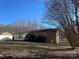 View of the back of the house, highlighting the sunroom and spacious yard at 228 Shadowbrook Rd, Mount Holly, NC 28120