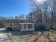 Sunroom and grilling patio area in the backyard of the home at 228 Shadowbrook Rd, Mount Holly, NC 28120