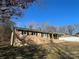 Ranch style brick home with attached carport and mature trees at 228 Shadowbrook Rd, Mount Holly, NC 28120