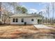 Back of house with gray roof, white siding, and small patio at 2503 Parnell Dr, Shelby, NC 28150