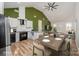 Open concept kitchen and dining area with green accent wall and modern finishes at 2503 Parnell Dr, Shelby, NC 28150