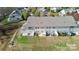 Back of townhome showing patio and surrounding landscape, including a lake view at 4146 La Crema Dr, Charlotte, NC 28214
