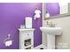 Purple-walled powder room with pedestal sink and white toilet at 4146 La Crema Dr, Charlotte, NC 28214