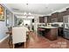 Kitchen and dining area with hardwood floors and dark brown cabinetry at 4146 La Crema Dr, Charlotte, NC 28214