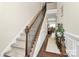 Two-story entryway with wood floors, a staircase, and a plant at 4146 La Crema Dr, Charlotte, NC 28214