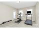 Home gym with various equipment including treadmill and elliptical at 4146 La Crema Dr, Charlotte, NC 28214
