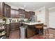 Modern kitchen with granite countertops, stainless steel appliances, and an island at 4146 La Crema Dr, Charlotte, NC 28214